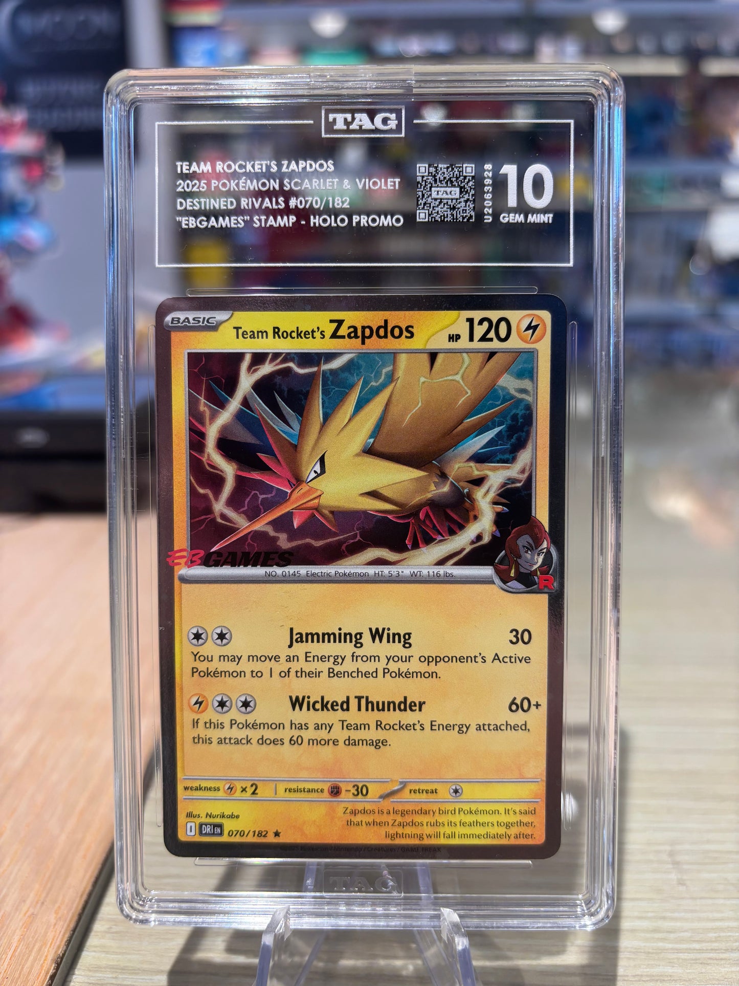TAG 10 - Team Rocket’s Zapdos - 070/182 - EB Games Stamp